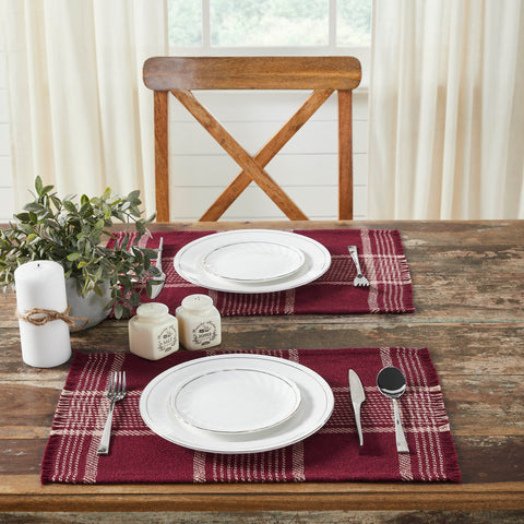 Create the perfect table settings with a timeless feel. The Eston Burgundy Tan Plaid Placemat Set includes two placemats measuring 13x19 inches each. The table place settings are constructed with a single layer of a cotton polyester blend and includes a fringed edge. The deep red base features deep tan stripes in a traditional tartan plaid pattern.