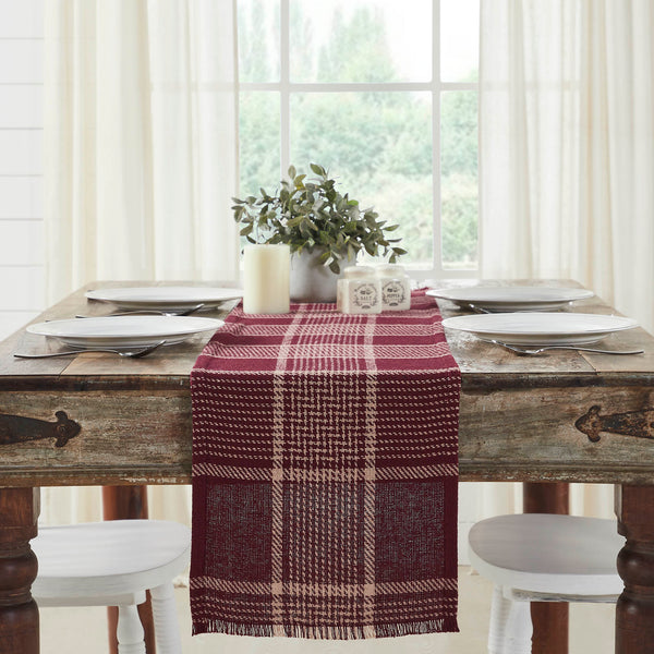 Give your tabletop decor a seasonal upgrade with traditional plaid in deep tones. The Eston Burgundy Tan Runner measures 12 by 60 inches and features a woven base in recycled cotton with frayed edging. The dark fall table runner features a burgundy base with deep tan striping. 