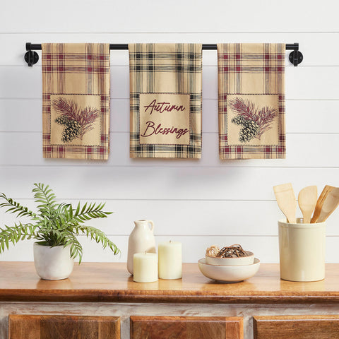 Add dark, fall charm to your primitive country kitchen with bold tones of black, burgundy and tan. The Connell Pinecone Tea Towel Set includes three unique tea towels measuring 19x28 inches each. The fall tea towels feature a tan base with striping for a plaid design. Two of the towels include burgundy stripes while the third includes soft black striping. The black tea towel includes the phrase, Autumn Blessings in a loopy script. The burgundy towels are adorned with small pinecone and pine needle motifs.
