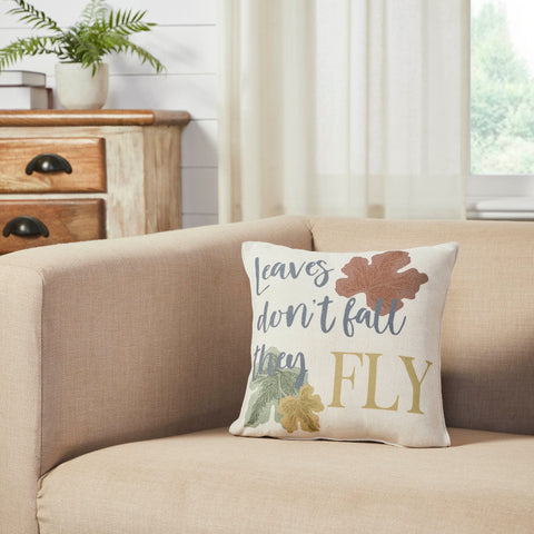 The Bountifall Leaves Fly Pillow measures 12x12 inches and is constructed with a water-resistant recycled plastic fabric. The reverse features a vintage grain sack stripe in cream and gold while the front is adorned with falling leaves in shades of gold, green and rust