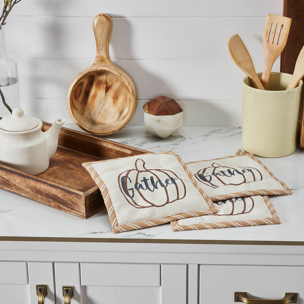 Add charming vintage style to your fall kitchen decor. The Bountifall Pumpkin Gather Trivet set includes three matching trivets measuring 8x8 inches each. The small kitchen pads feature striped fabric in a deep gold. The front of the trivets features simple creme fabric with a pumpkin print in burnt orange.