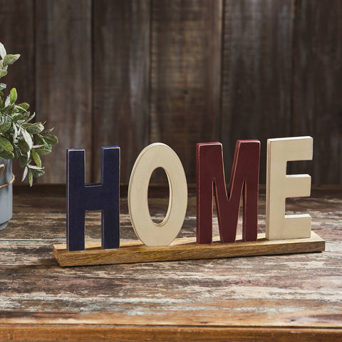 Elevate your Independence Day Decor with the VHC Brands Patriotic RWB HOME Wooden Block, a charming figurine measuring 14x6.25x2.25 inches. Crafted from MDF in a distressed finish, this rectangular block showcases the proud display of "HOME" in patriotic red, white, and blue text. 