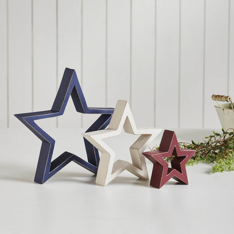 Patriotic Wooden Nested Stars White 3-in-1 set. This charming ornament ensemble consists of three stars that nest inside each other, collectively measuring 10x10x1.5 inches. Crafted from high-quality tropical wood, each star features a distinctive distressed appearance, adding rustic elegance to your decor. 