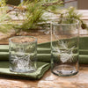 Set of four clear beverage glasses with etched pinecone and pine branch design for rustic lodge and country kitchen decor