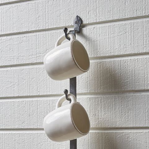 This functional yet space saving Forged Iron Wall Mug Rack is an interpretation of a forged gate latch found in the gardens of Colonial Williamsburg! Simple, but elegant!
