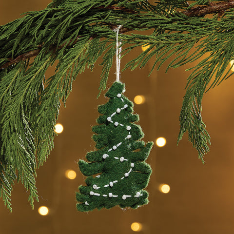 Christmas Tree Felt Ornament is a felt ornament in the shape of a green pine tree decorated with white string lights. The tree is accented with white embroidery and white beads to make a string of lights. Item is slightly filled for a weighted feel. Includes a string for hanging on the Christmas tree.