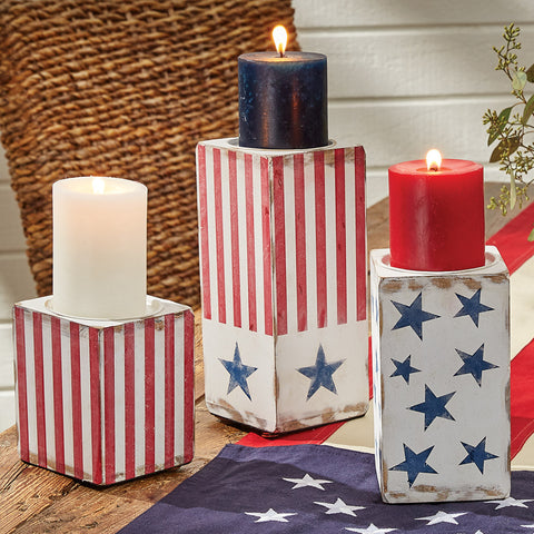 Star Spangled Candlesticks- Set of 3! Featuring three candlesticks of varied heights. One in red and white stripes, one in white with blue stars and on with both red and white strips and blue stars. This collection is a lovely tribute to our country that can be used not just on July 4th, but all year long!  DIMENSIONS: S=5"H X 4"SQ, M=7"H X 4"SQ, L=9"H X 4"SQ