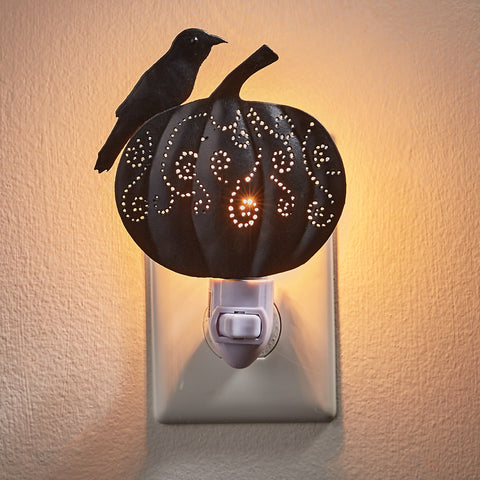 Fall country charm awaits you with this unique Pumpkin and Crow Night Light.  Features a black crow perched atop a charming pumpkin that is skillfully crafted with punched details that allows light to glow through, creating warmth and interest to darker areas of the home and providing a helpful guiding light.  At night it softly illuminates with a warm glow that is ideal for entryway, stairs, kitchen or bathroom