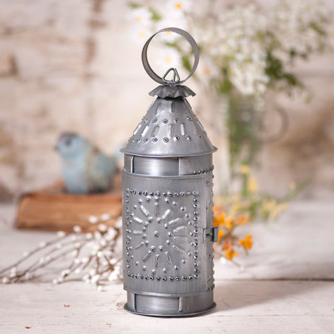A petite 9-Inch Revere Lantern is just the answer for what's needed in that small vignette. With all the details of our larger lanterns, this smaller version is an adorable addition to your home decor. Antique Tin finish. For use with a battery operated tea light. Metal construction. Imported.