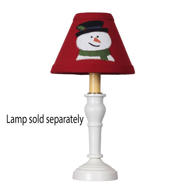 Flurry Snowman Lampshade in rich red fabric featuring a snowman applique displayed on a candle lamp for primitive Christmas decorating.