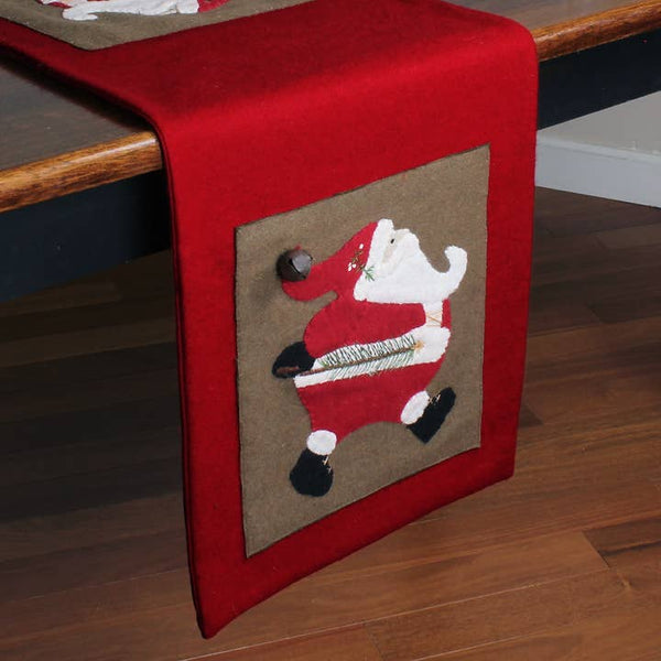 Ol' Saint Nick Table Runner featuring appliquéd Santa Claus designs with dimensional bell accents on a red background, perfect for primitive farmhouse Christmas decorating.