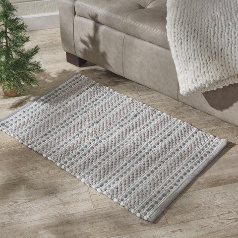 Add calming and stylish touches to your holiday decor with the All Is Calm Chindi Rug! Featuring a soothing combination of pewter and oatmeal with an accent of lurex sparkle, these placemats will be the perfect winter addition to your home!