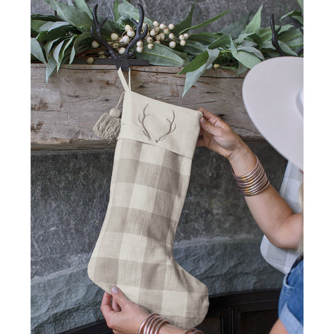 Add a stylish touch to your holiday decor with the Signature Antler Christmas Stocking! Featuring a gray and white check design with embroidered antler accent, these stockings are sure to be a charming addition to your mantle!