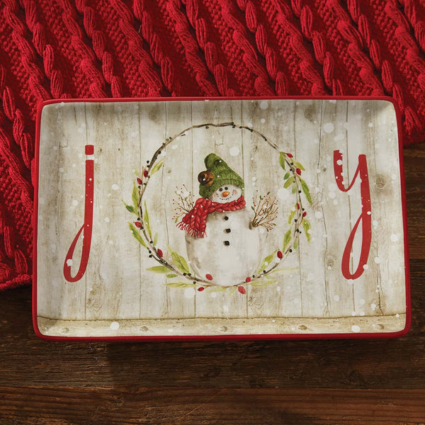 Add a gorgeous touch to your winter country kitchen decor with the Farmhouse Snowman Platter! Featuring a whimsical snowman and the word "joy," this platter is perfect for the holidays!