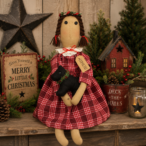 Caroline Christmas primitive doll in a red plaid dress holding a plush black dog with festive holiday accents.