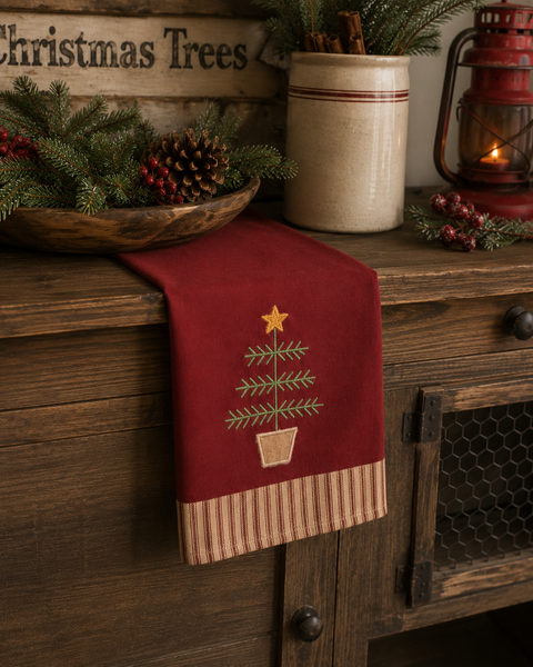 Primitive Feather Tree Christmas towel with star topper and ticking stripe border on a barn red background.