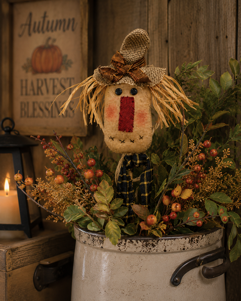 Primitive 15-inch scarecrow floral pick with burlap hat, raffia hair, and gingham bow for fall decorating.