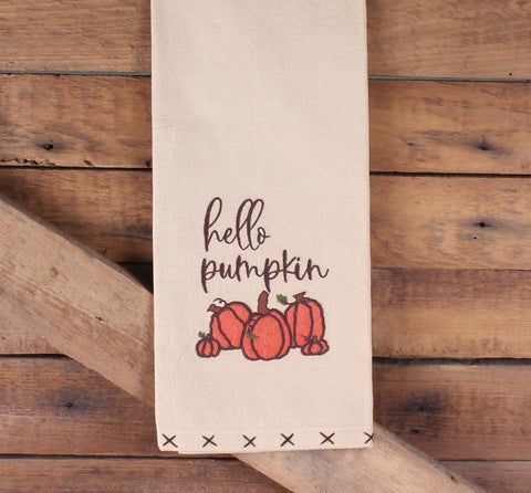 “Close-up of Hello Pumpkin embroidery and orange pumpkins”