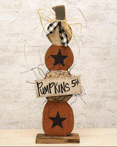 Rustic skinny wood pumpkin stack with orange and cream pumpkins, black stars, gingham ribbon, raffia, and Pumpkins 5¢ sign