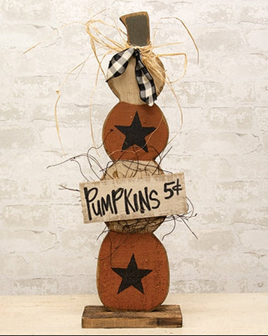 Rustic skinny wood pumpkin stack with orange and cream pumpkins, black stars, gingham ribbon, raffia, and Pumpkins 5¢ sign