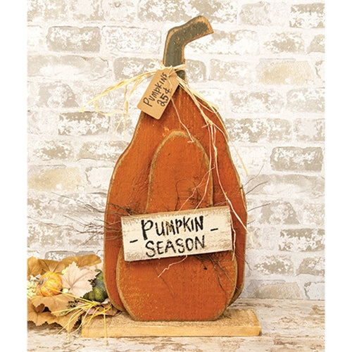 Rustic layered wood pumpkin sign with distressed orange finish, Pumpkin Season plaque, raffia accents, and natural wood base