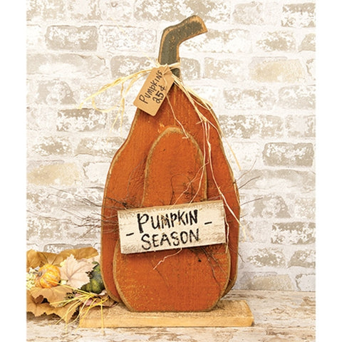 Rustic layered wood pumpkin sign with distressed orange finish, Pumpkin Season plaque, raffia accents, and natural wood base