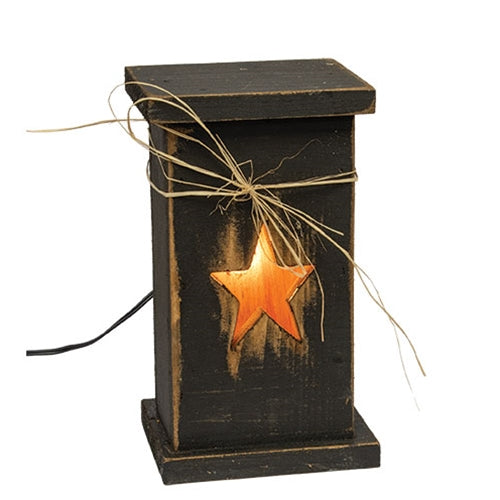 Black rustic wood lighted pedestal with glowing star cutout and raffia bow on top.