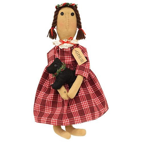 Caroline Christmas primitive doll in a red plaid dress holding a plush black dog with festive holiday accents.
