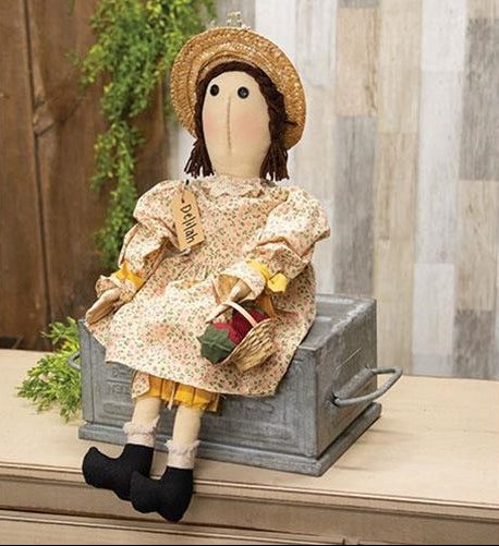 Delilah primitive doll wearing a floral dress and straw hat while holding a basket of summer berries.