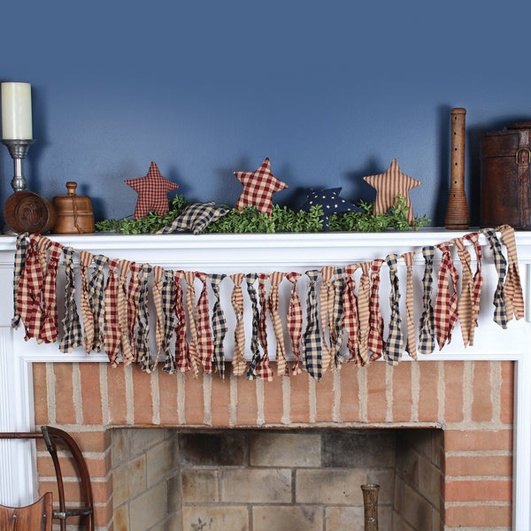 Liberty fabric ties rag garland in multi country prints draped on a farmhouse mantel.