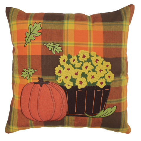 Farmhouse-style autumn plaid pillow with embroidered pumpkin, mums, and fall leaves on a warm orange plaid background.