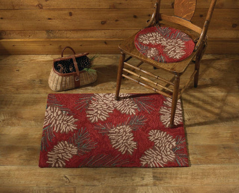 Bring the outdoors into your home with the lively Pinecone Hooked Rug! The rich red base provides a pop of color with the classic pinecone design! Available in 2 sizes!