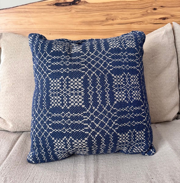 Navy and tan coverlet-style 16×16 pillow on a sofa—Nantucket pattern for primitive farmhouse décor.