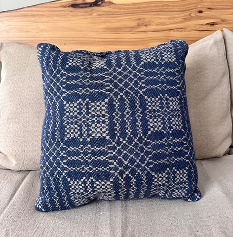 Navy and tan coverlet-style 16×16 pillow on a sofa—Nantucket pattern for primitive farmhouse décor.