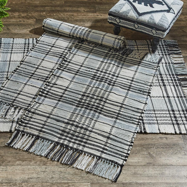 Add charming style to your decor with the Refined Rustic Rag Rug! Featuring a classic plaid design in tones of antique white, gray, and black, these rugs will be an elegant touch to your country home! The fringed edges are the perfect finishing touch! Complete the look with the rest of the Refined Rustic collection! Available in 3 sizes (each sold separately).