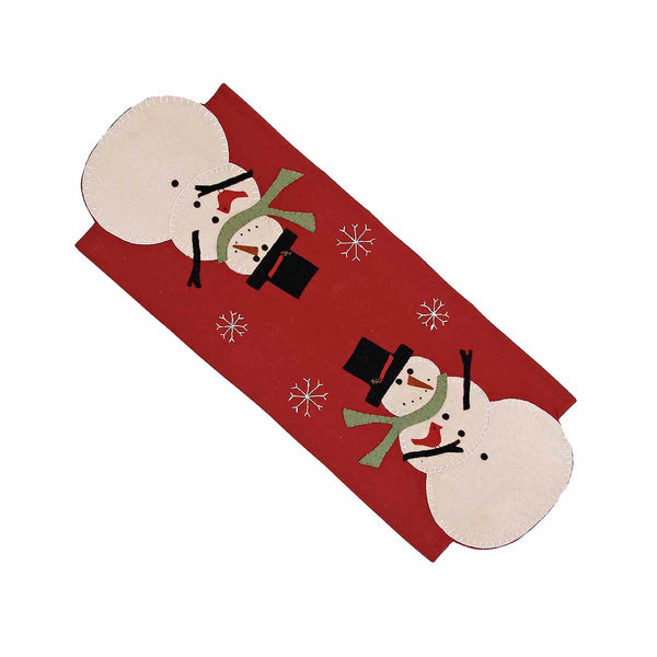 Snow Guy Table Runner featuring whimsical snowmen with black top hats, green scarves, and cardinal accents on a barn red background. Primitive Christmas table runner measuring 14x36 inches.