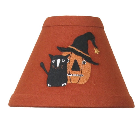 Primitive Halloween candle lamp shade featuring a black cat beside a jack-o'-lantern wearing a witch's hat on a pumpkin spice background.