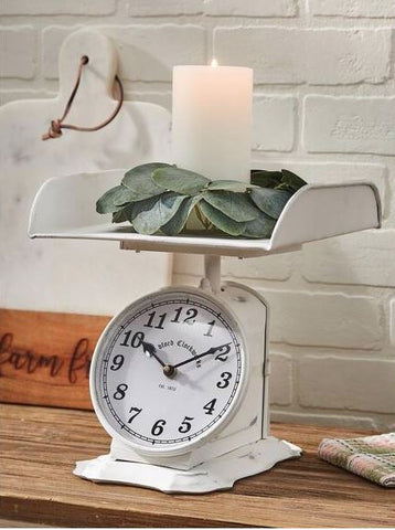 Keep track of time and add a stylistic touch to your space with this rustically charming clock and lifted tray. Features a simple clock face on a decorative scale in white to use for placing kitchen items or trinkets. Whether placed in your living room, foyer or just about anywhere, this vintage clock will be a great addition to your home.