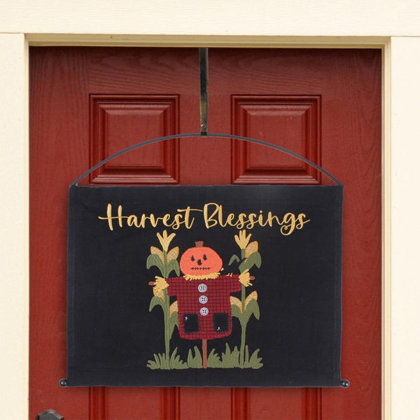 Primitive Harvest Blessings pumpkin scarecrow pennant displayed on a red front door with an arch metal hanger.