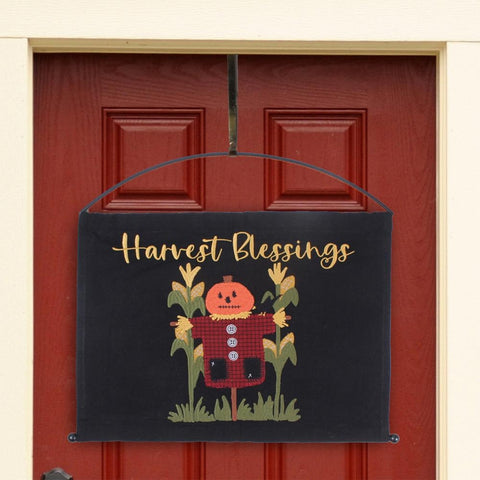 Primitive Harvest Blessings pumpkin scarecrow pennant displayed on a red front door with an arch metal hanger.