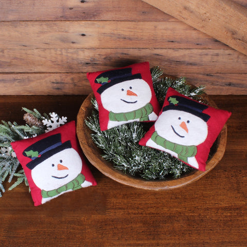 Primitive Flurry the Snowman bowl fillers featuring smiling snowmen with green scarves on a red background.