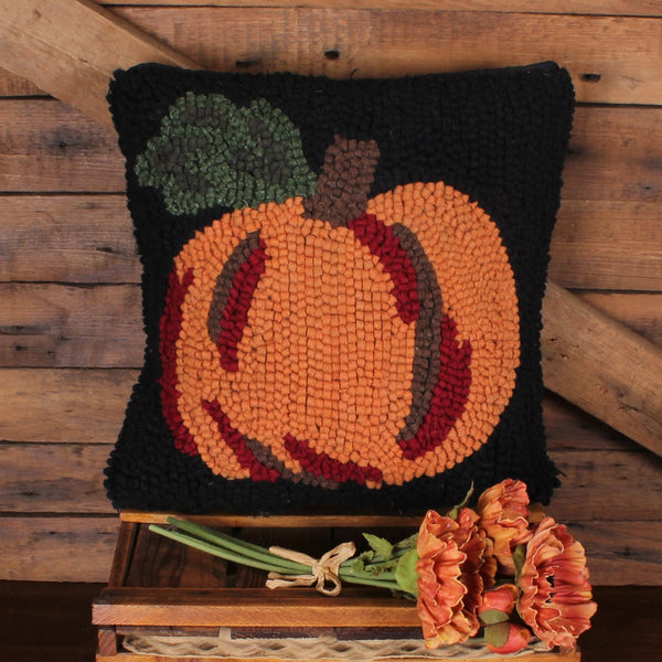 14-inch wool hooked pumpkin accent pillow with orange pumpkin on black background for primitive country fall home decor.
