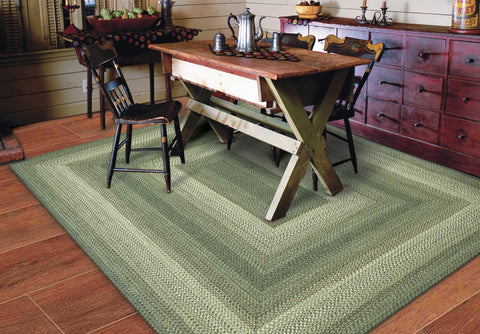 Waterproof indoor/outdoor braided rug in Cedar Ridge pattern, green, tan, and brown tones, washable and reversible.