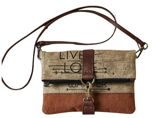 Command the attention of fellow travelistas and sight-see in style with the Live, Love, Wander Collection. Made from up-cycled canvas, this rustic fold-over crossbody is equipped for all your adventures.