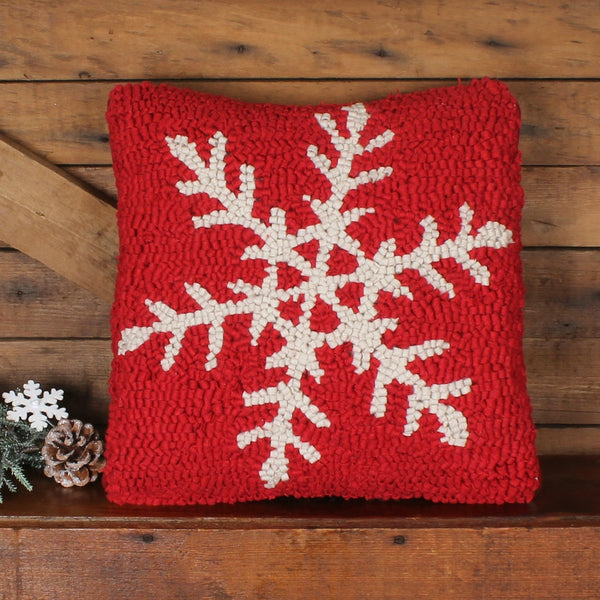 Snowflake Hooked Pillow featuring large ivory snowflakes on a festive red hooked wool background.