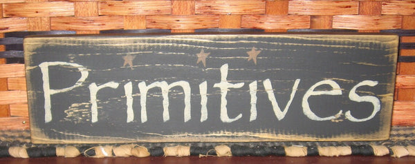 Primitive Country Primitives 12" sign is painted black with antique white lettering and is sanded and stained for a primitive look. It measures 12" x 3.5" and is made from 3/4" pine wood which may have imperfections such as knots, raised grain or other markings. It is routed in the back for easy hanging. No two are exactly the same.