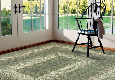 Waterproof indoor/outdoor braided rug in Cedar Ridge pattern, green, tan, and brown tones, washable and reversible.