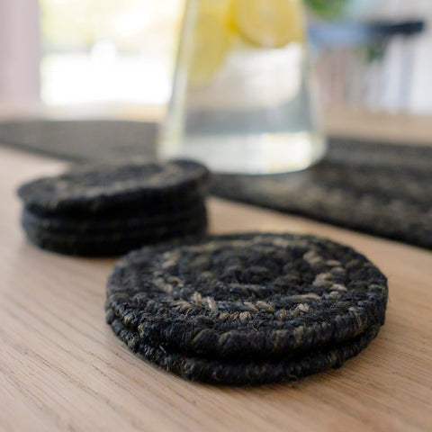 Set of six Jet Black braided jute coasters featuring black, charcoal, brown and tan tones in a handcrafted braided design