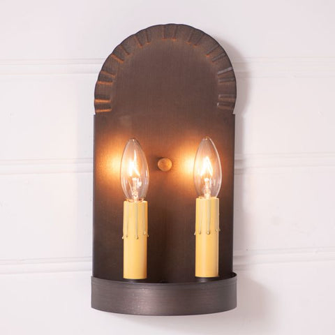 Handcrafted in Pennsylvania, this 2-Light Colonial Tin Sconce in Kettle Black adds a warm, primitive glow to any room. Direct wired, made in the USA.
