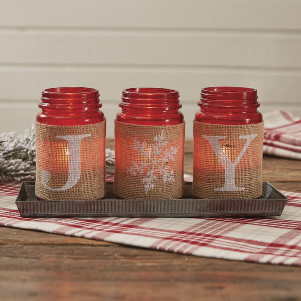 This fluted metal tray holds three cheery red glass mason jars, each with a burlap wrapper printed to spell JOY. Just the right accent for your country farmhouse style Christmas table. Use with tealights or fill with candy canes!